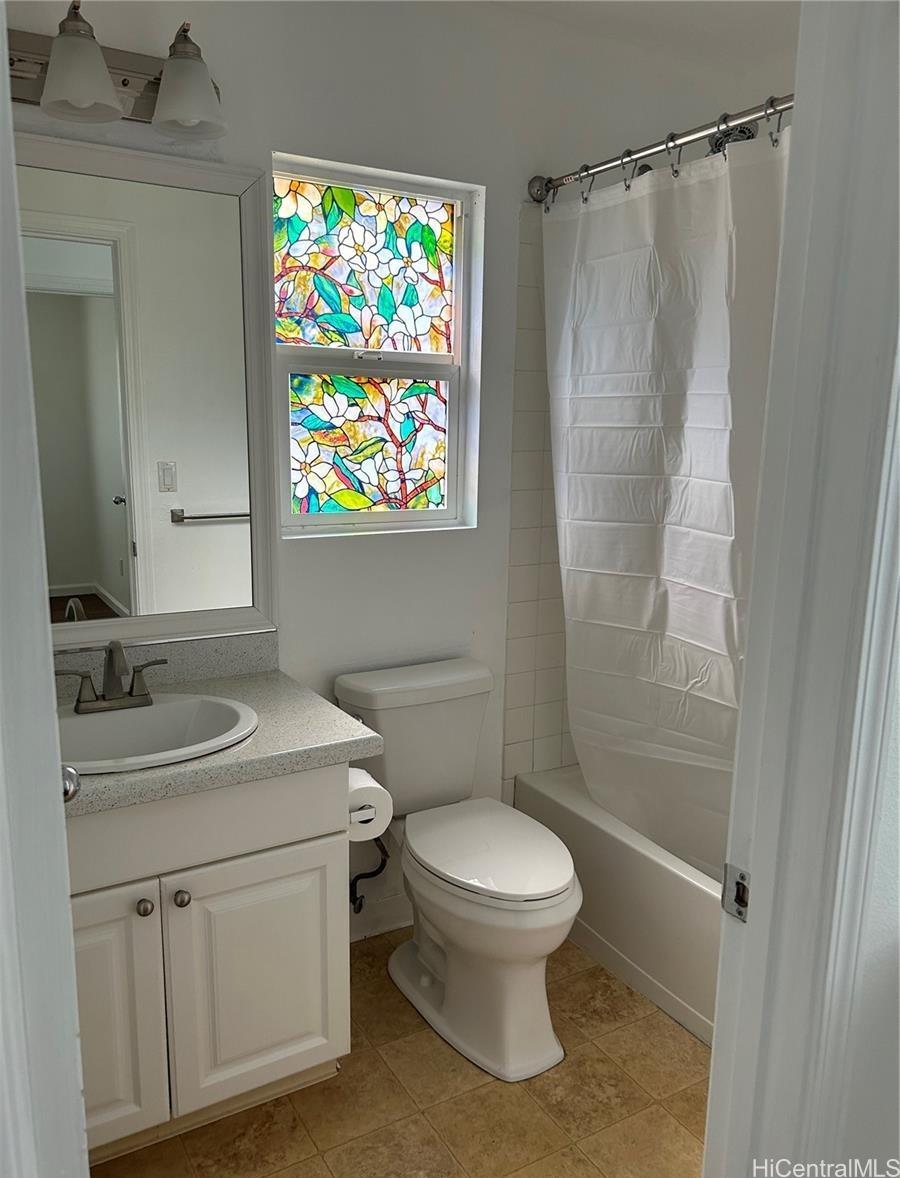 91-1179 Kaimalie Street Ewa Beach, HI 96706 - Photo 12 of 16 a bathroom with a sink a toilet and shower