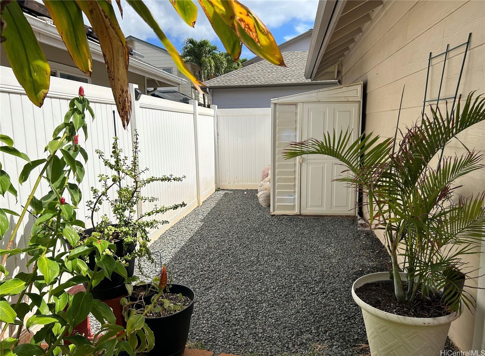91-1179 Kaimalie Street Ewa Beach, HI 96706 - Photo 14 of 16 a potted plant sitting in front of a house