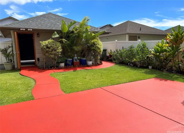 a view of a house with a yard and potted plants