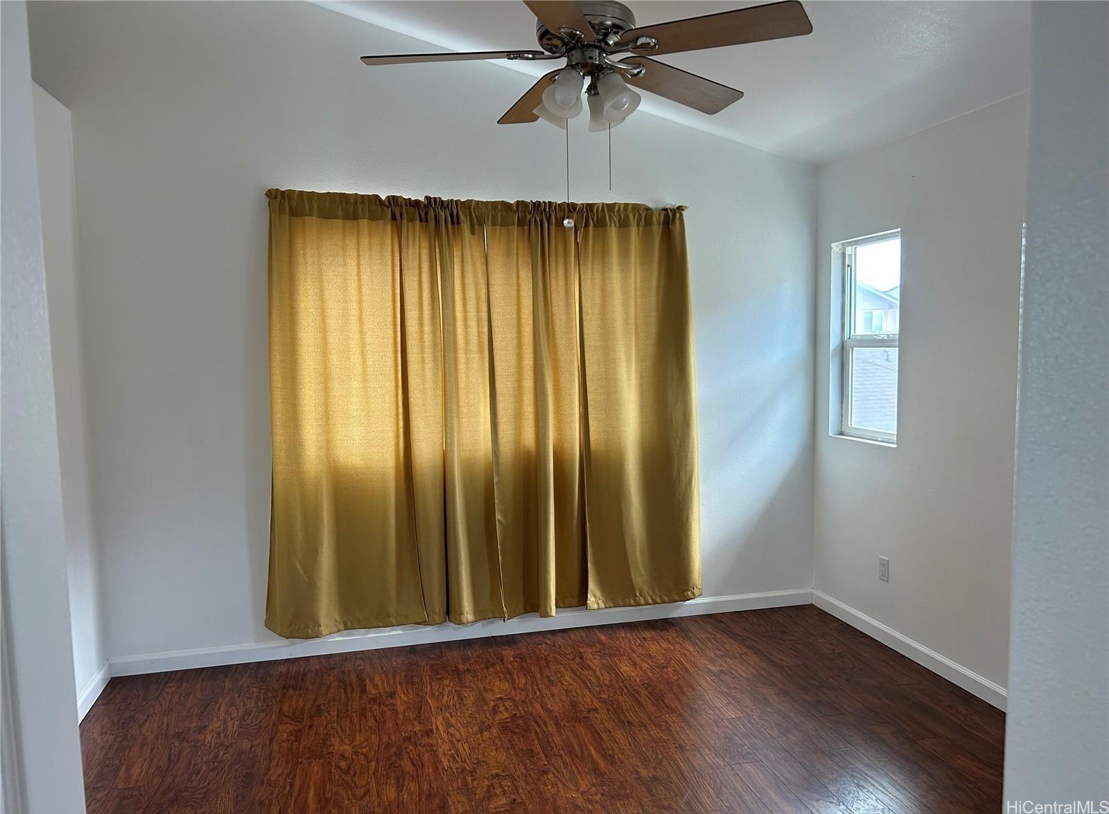 91-1179 Kaimalie Street Ewa Beach, HI 96706 - Photo 6 of 16 an empty room with wooden floor closet and windows
