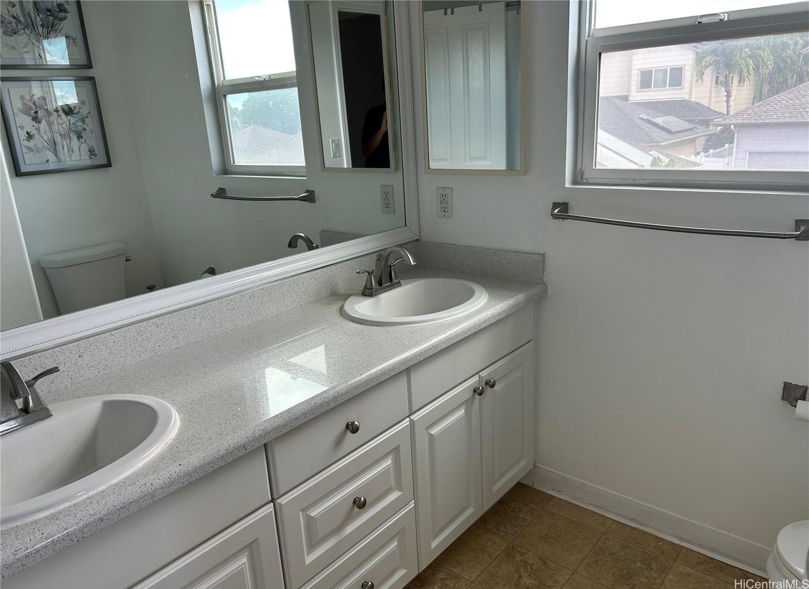 91-1179 Kaimalie Street Ewa Beach, HI 96706 - Photo 8 of 16 a bathroom with a sink and a window
