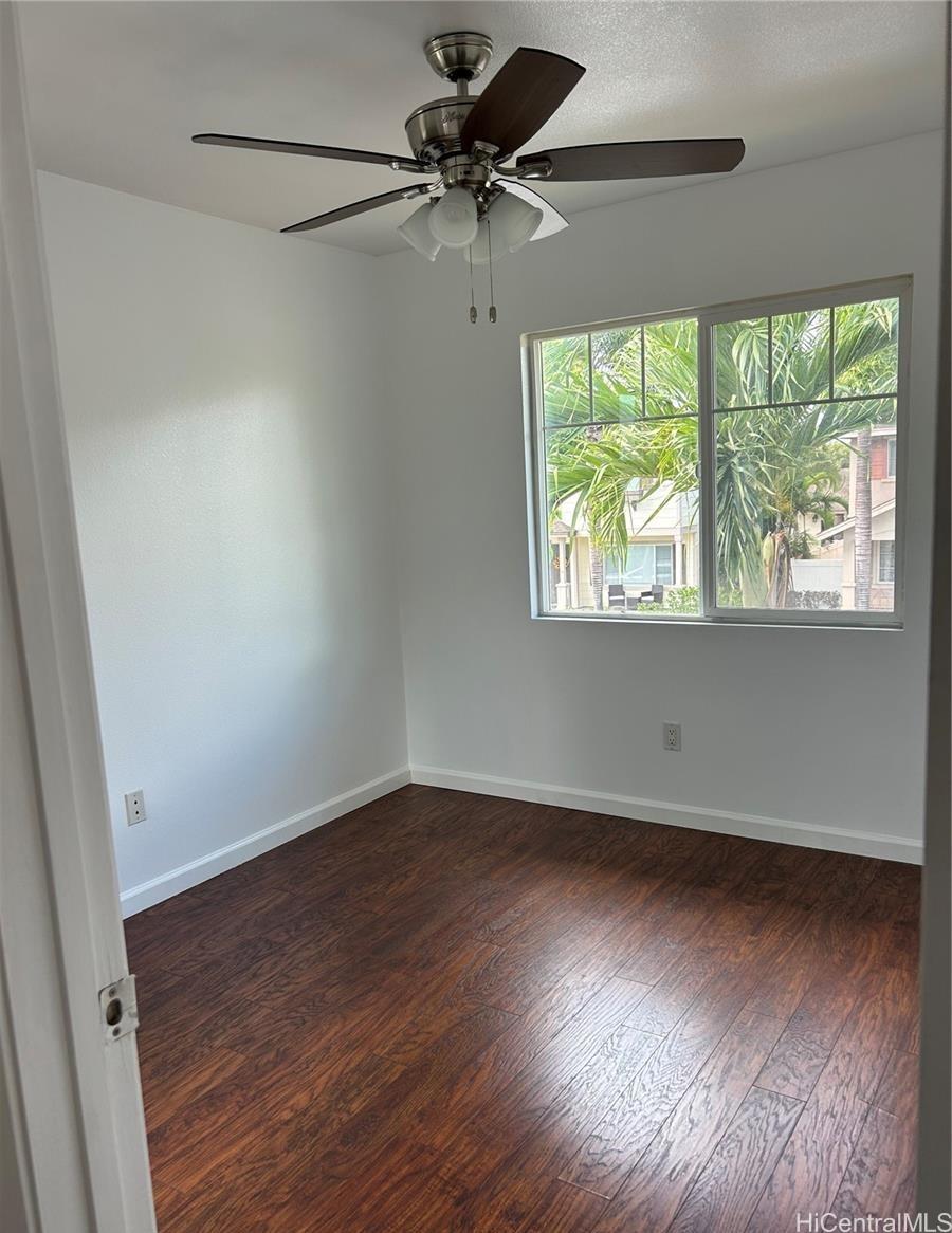 91-1179 Kaimalie Street Ewa Beach, HI 96706 - Photo 10 of 16 an empty room with wooden floor and windows