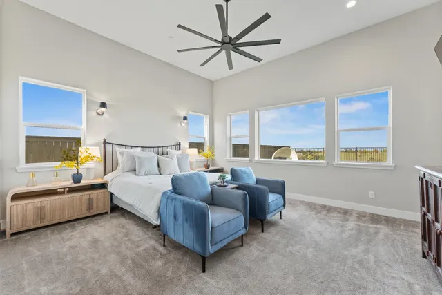 a bedroom with furniture and a large window