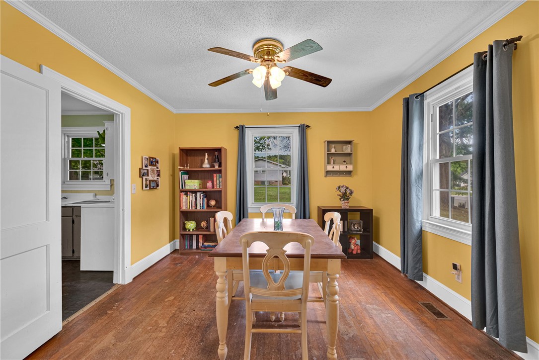 102 Graham Honea Path, SC 29654 - Photo 8 of 29 A cheerful dining space boasts rich hardwood flooring and a stylish ceiling fan, perfect for any gathering.