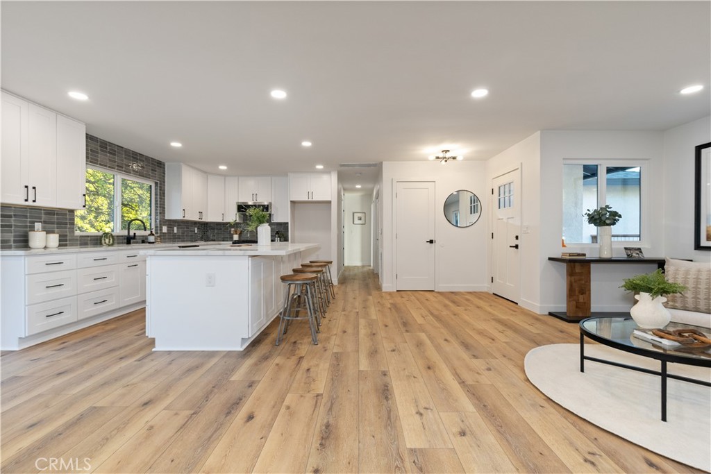 4150 Lobos Avenue Atascadero, CA 93422 - Photo 20 of 59 a large white kitchen with wooden floors and white stainless steel appliances