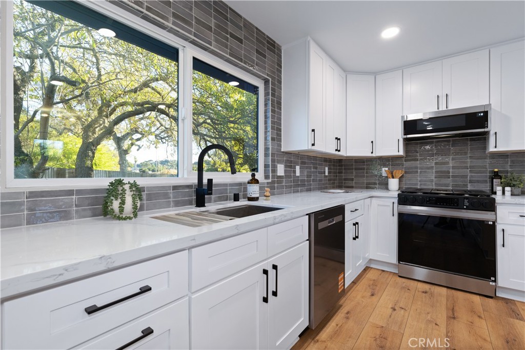 4150 Lobos Avenue Atascadero, CA 93422 - Photo 28 of 59 a kitchen with granite countertop a sink stainless steel appliances and cabinets