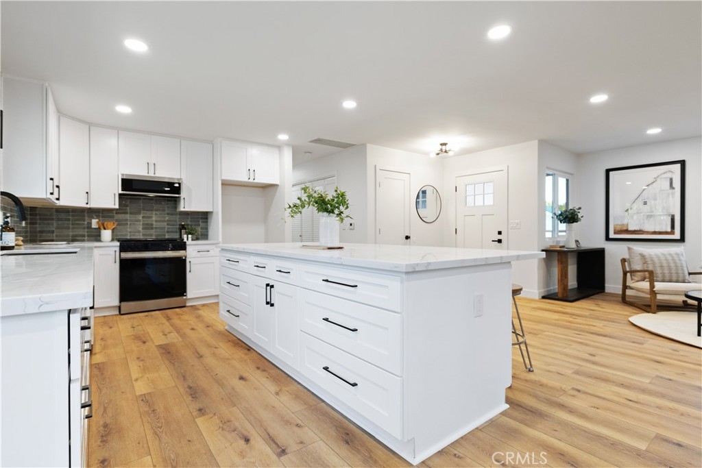 4150 Lobos Avenue Atascadero, CA 93422 - Photo 30 of 59 a large kitchen with stainless steel appliances kitchen island granite countertop a stove a sink a refrigerator and white cabinets