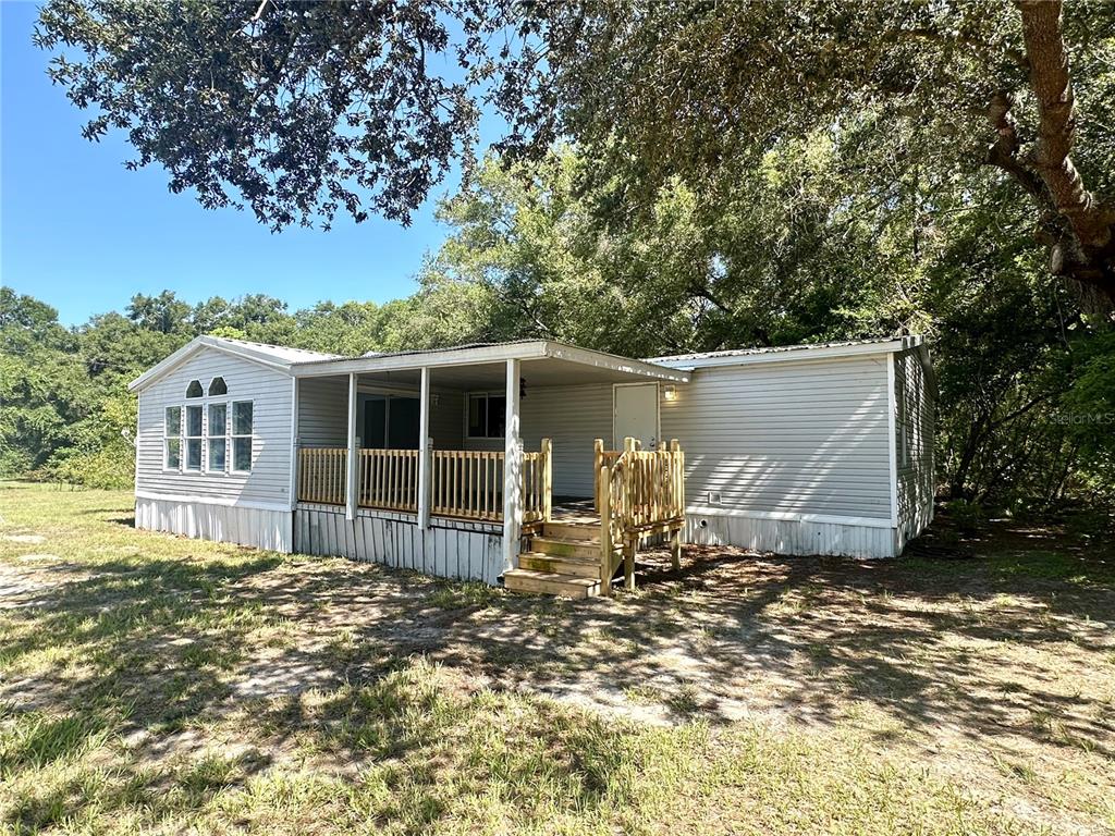 5450 Cemetery Road Mount Dora, FL 32757 - Photo 1 of 1 a front view of a house with garden