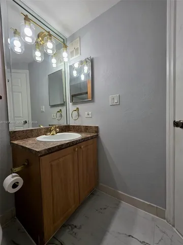a bathroom with a double vanity sink and mirror