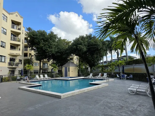 a view of multiple houses with palm trees