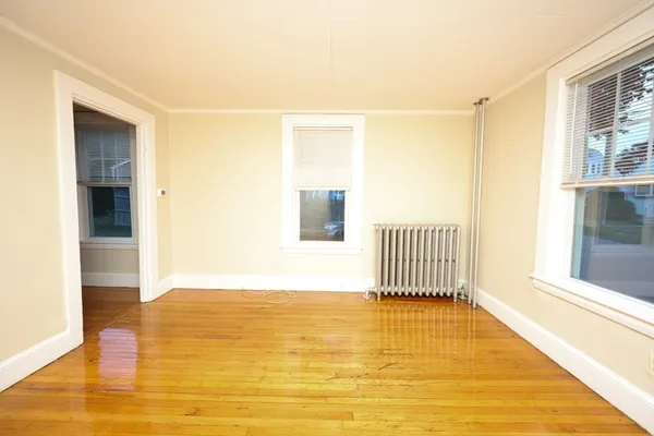 a view of a room with wooden floor