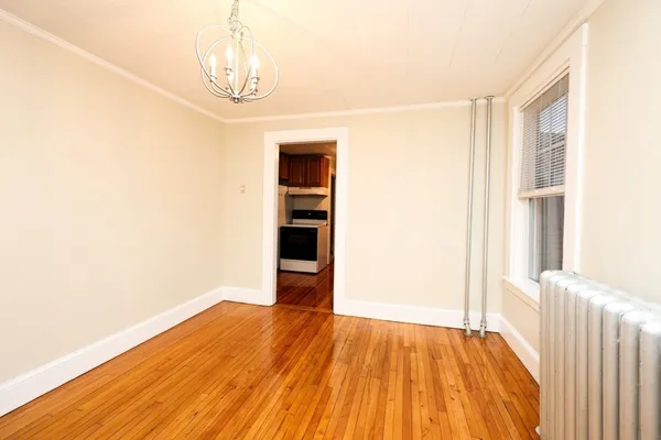 a view of a room with wooden floor and a window