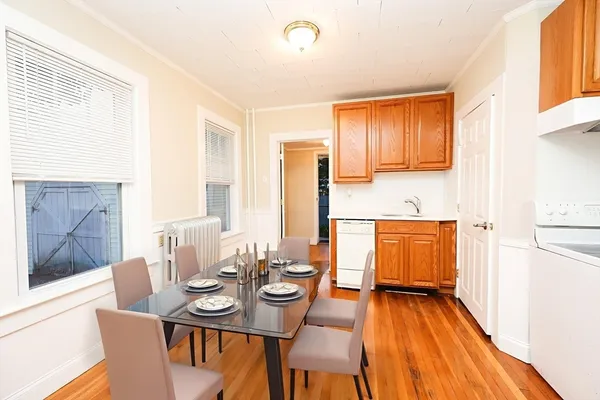 a view of a dining room with furniture window and wooden floor