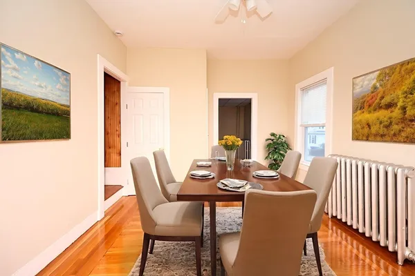 a dining room with furniture a rug and wooden floor
