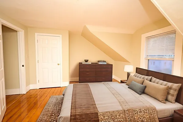 a bedroom with a large bed and a window