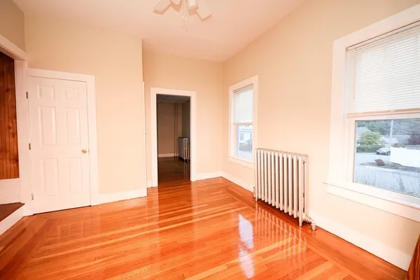 a view of a room with wooden floor and fence