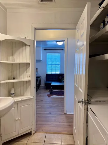 a room with a wooden floor and cabinets