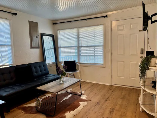 a living room with furniture a rug and a window
