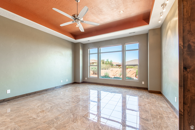 322 340 E Street Ivins, UT 84738 - Photo 24 of 61 Spacious room featuring large windows, wood-finish flooring, a tray ceiling with a ceiling fan, recessed lighting, and track lighting