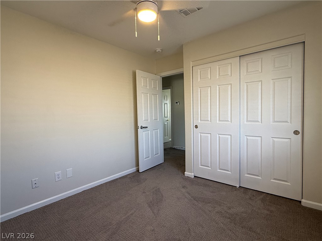 1908 Thunder Ridge Circle Henderson, NV 89012 - Photo 23 of 28 A comfortable bedroom with soft carpet flooring and convenient sliding closet doors.