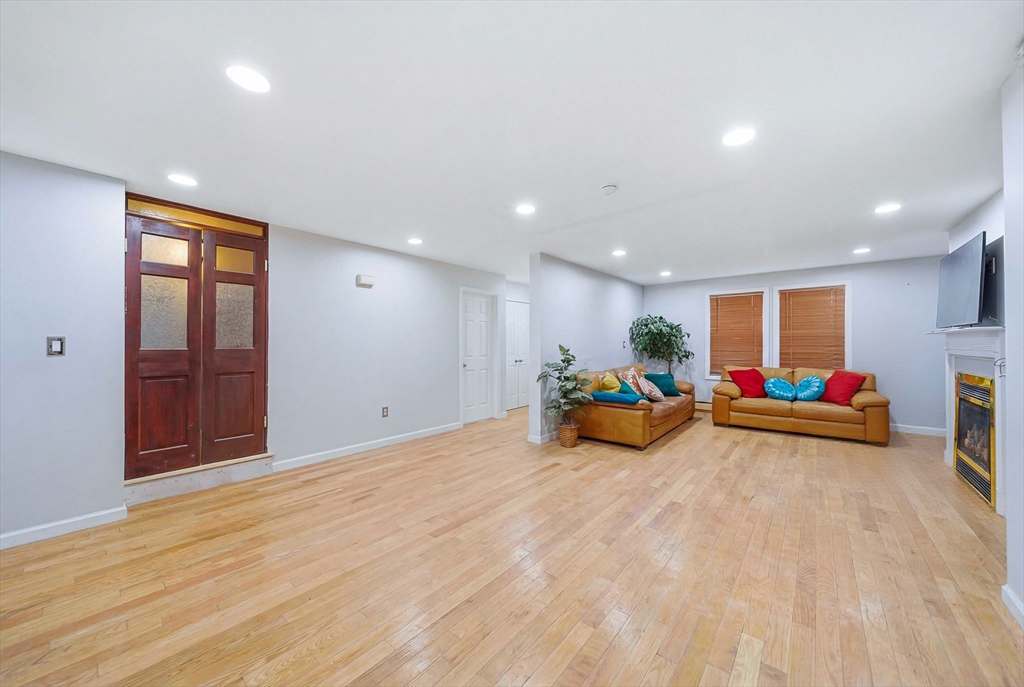 39 Hawthorne Street, Unit 39 Boston, MA 02119 - Photo 7 of 33 a view of a room with furniture and wooden floor