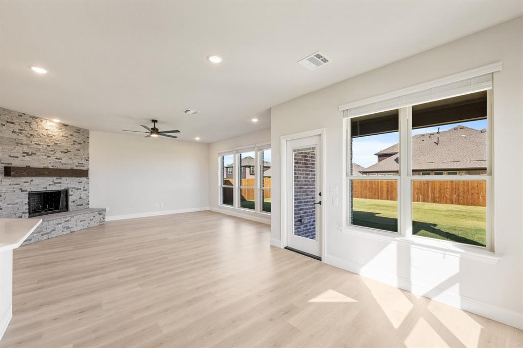 2000 Hickory Chase Lane Anna, TX 75409 - Photo 11 of 40 a view of an empty room with a fireplace and a window