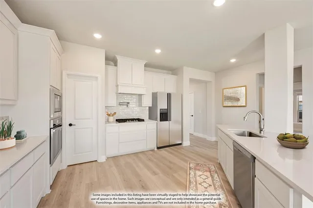 a kitchen with refrigerator and cabinets