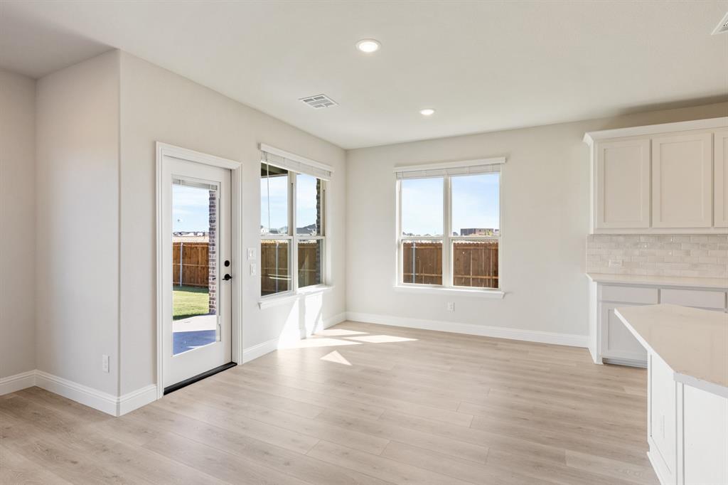 2000 Hickory Chase Lane Anna, TX 75409 - Photo 16 of 40 a view of an empty room with wooden floor and a window