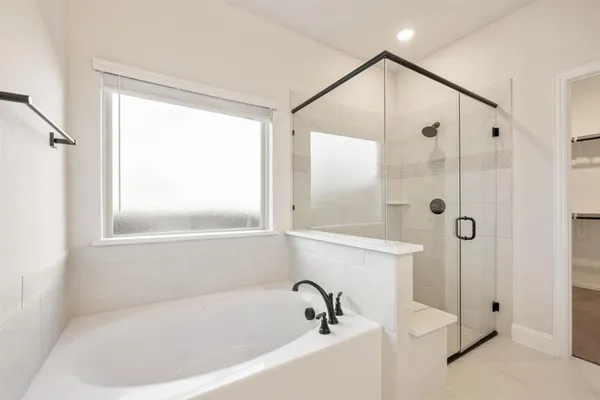 a white bath tub sitting next to a shower