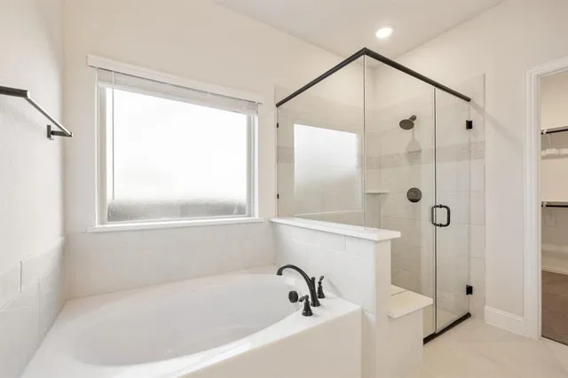 a white bath tub sitting next to a shower