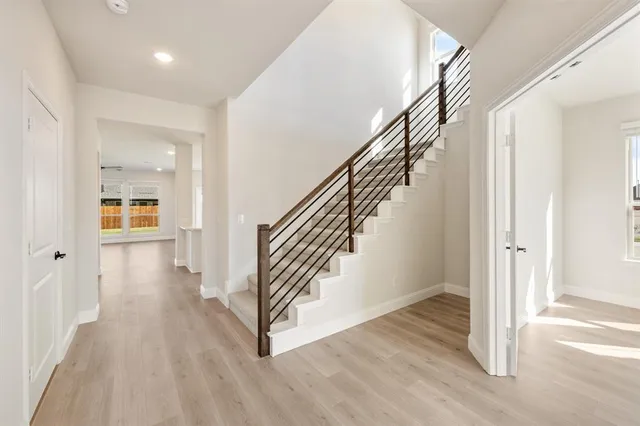 a view of a hallway with wooden floor and entryway