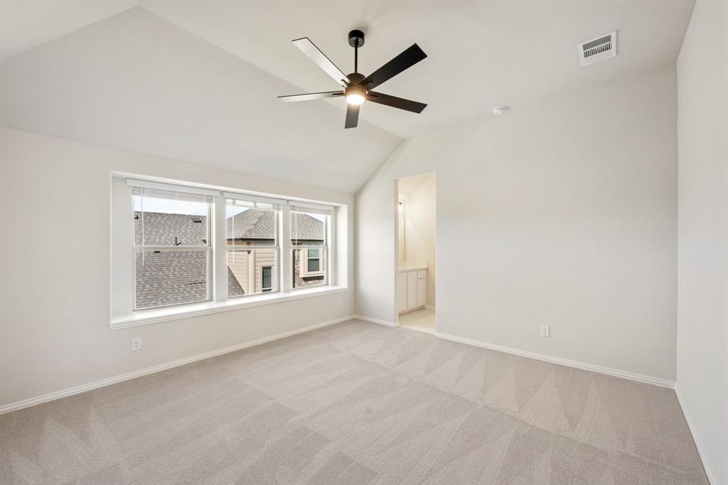 2000 Hickory Chase Lane Anna, TX 75409 - Photo 29 of 40 an empty room with large windows and ceiling fan