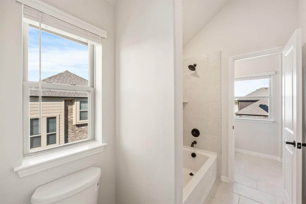 2000 Hickory Chase Lane Anna, TX 75409 - Photo 31 of 40 a bathroom with a bathtub shower and toilet