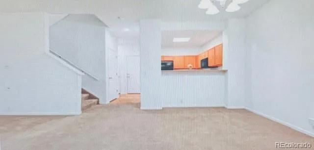 a view of an empty room with stairs