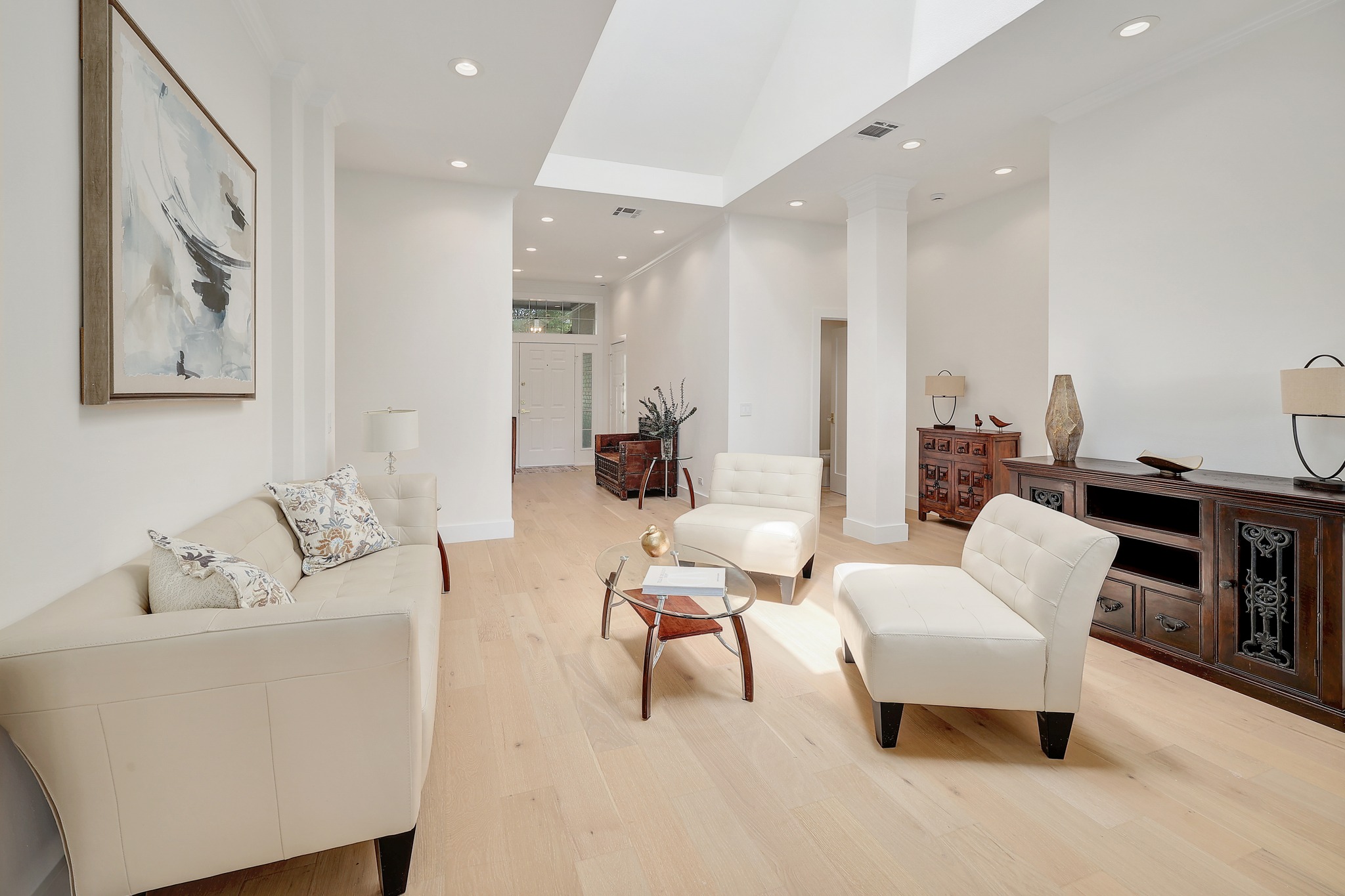 7705 Jester Boulevard Austin, TX 78730 - Photo 3 of 36 Recessed lighting illuminates this bright, open-concept living area with light hardwood floors.