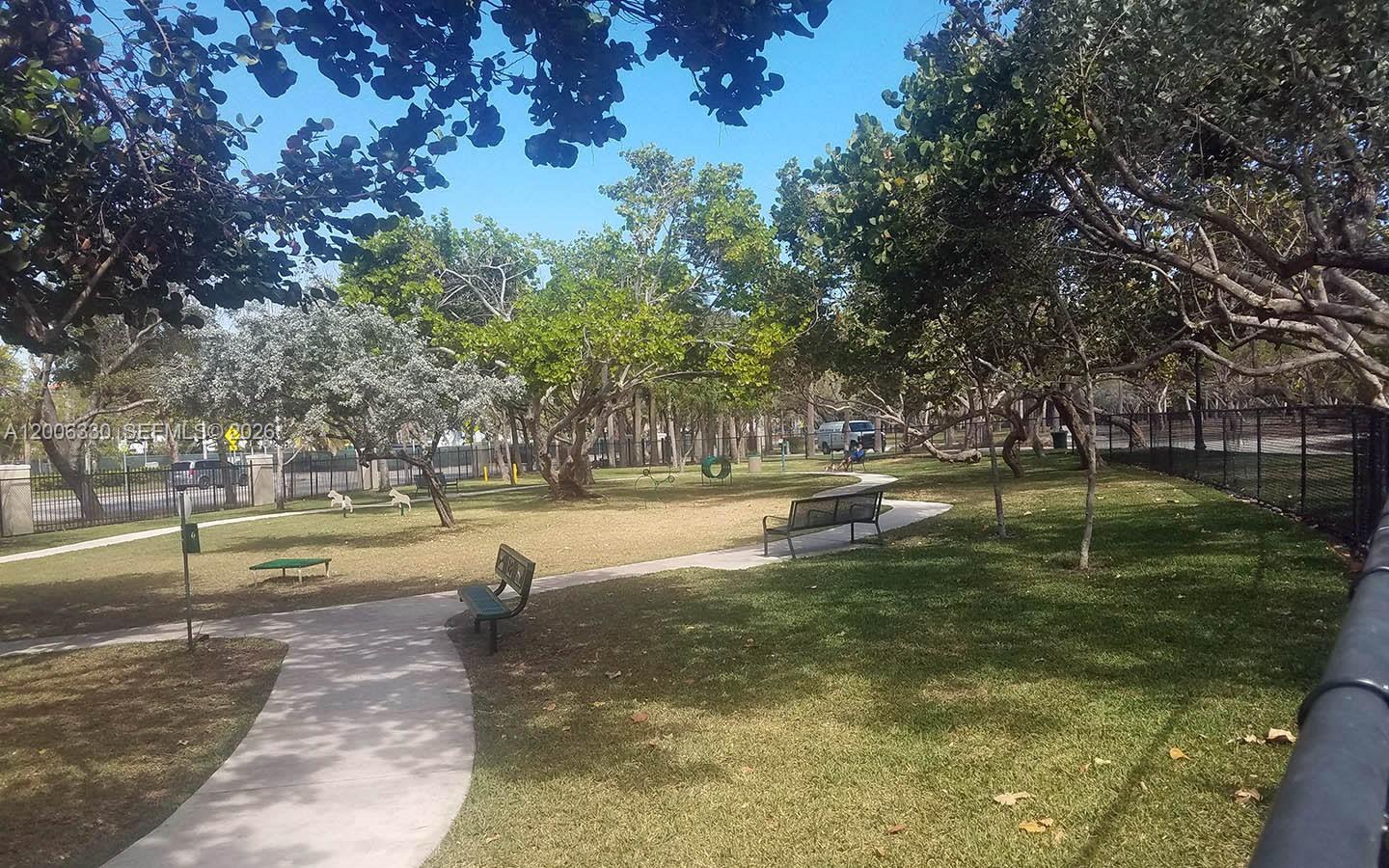 7920 Harding Avenue, Unit 9 Miami Beach, FL 33141 - Photo 12 of 13 a swimming pool with outdoor seating and yard
