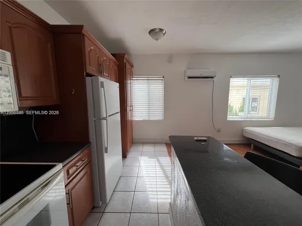 a kitchen with a refrigerator and a stove
