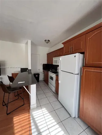a kitchen with stainless steel appliances a refrigerator sink and cabinets