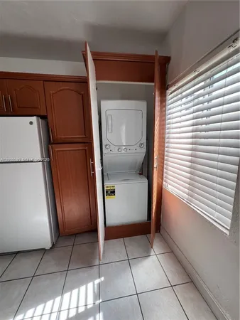 a kitchen with a refrigerator and a refrigerator