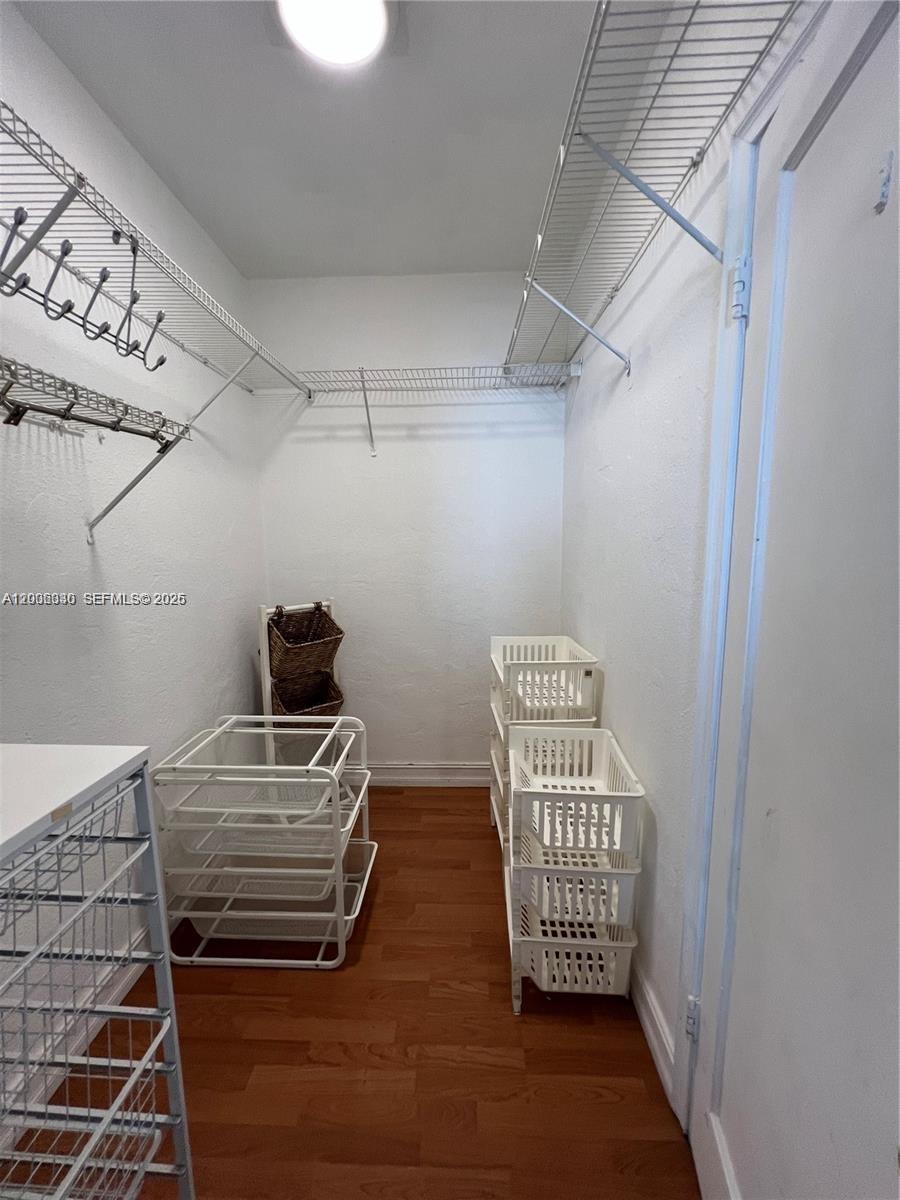 7920 Harding Avenue, Unit 9 Miami Beach, FL 33141 - Photo 9 of 13 a view of room with stairs and wooden floor