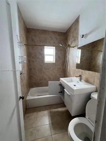 a bathroom with a toilet bathtub and sink