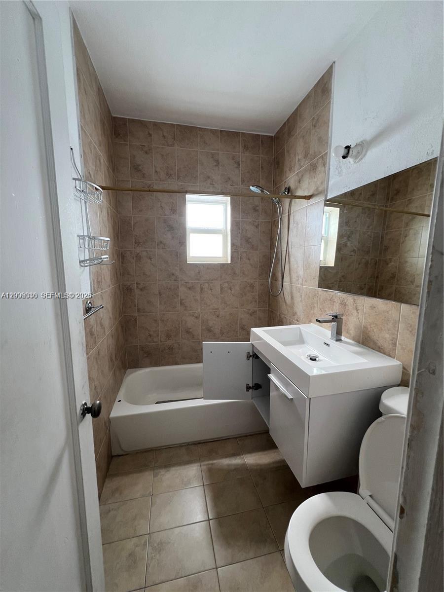 7920 Harding Avenue, Unit 9 Miami Beach, FL 33141 - Photo 10 of 13 a bathroom with a toilet bathtub and sink