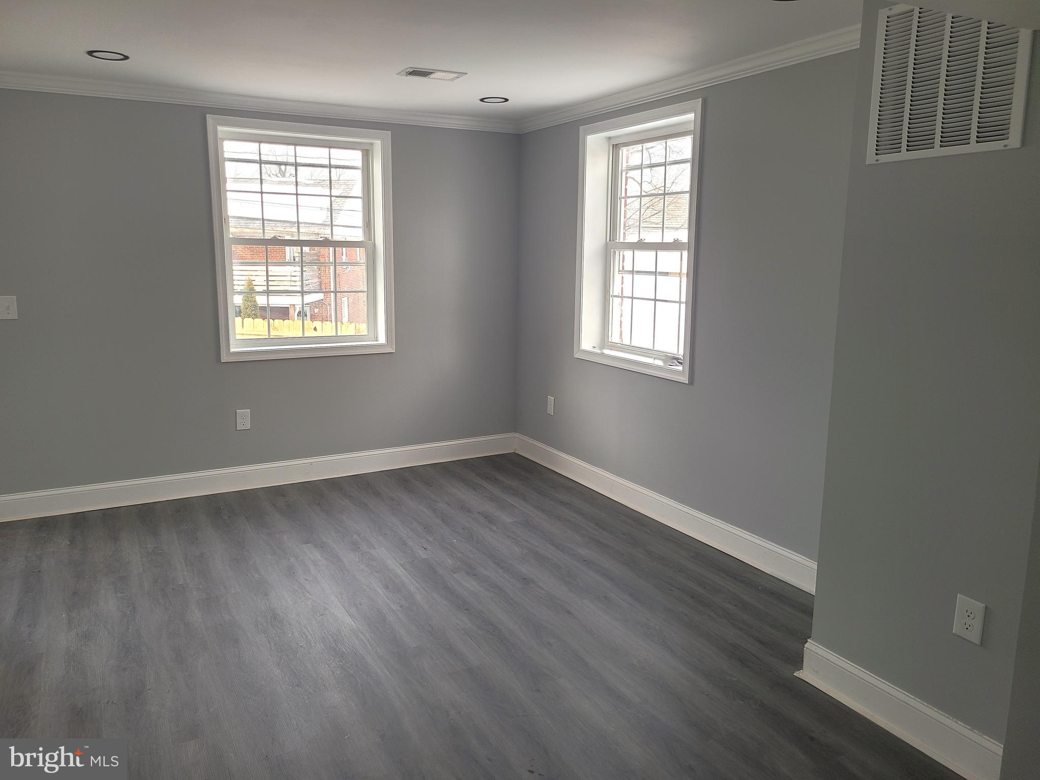 402 Croydon Road Baltimore, MD 21212 - Photo 3 of 4 an empty room with wooden floor and windows