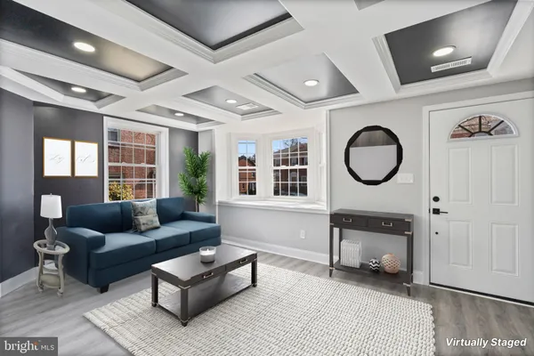 a living room with furniture a rug and a window