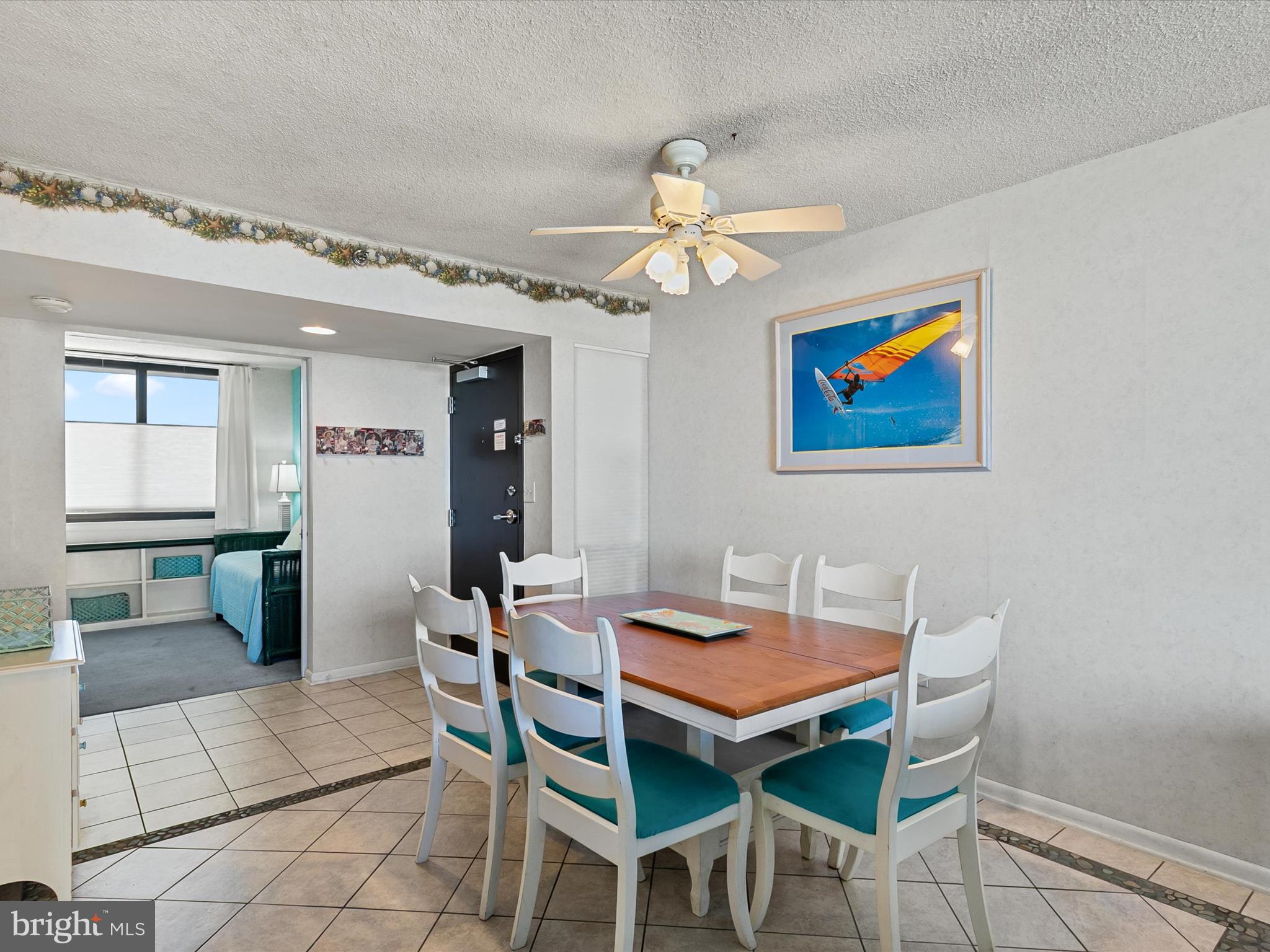 311 Georgetown House Bethany Beach, DE 19930 - Photo 12 of 48 a view of a dining room with furniture and a chandelier