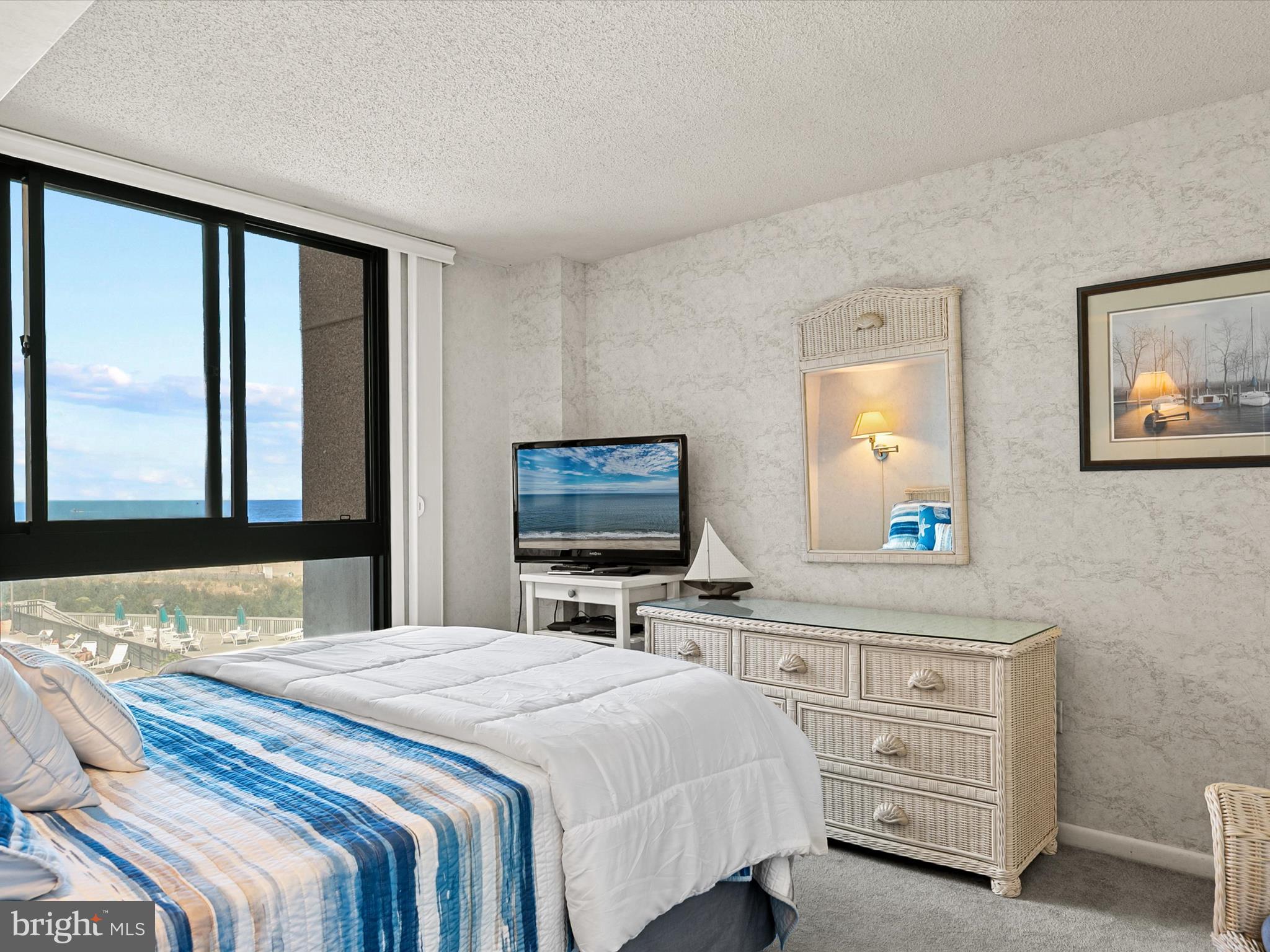 311 Georgetown House Bethany Beach, DE 19930 - Photo 18 of 48 a bedroom with a bed and a flat screen tv