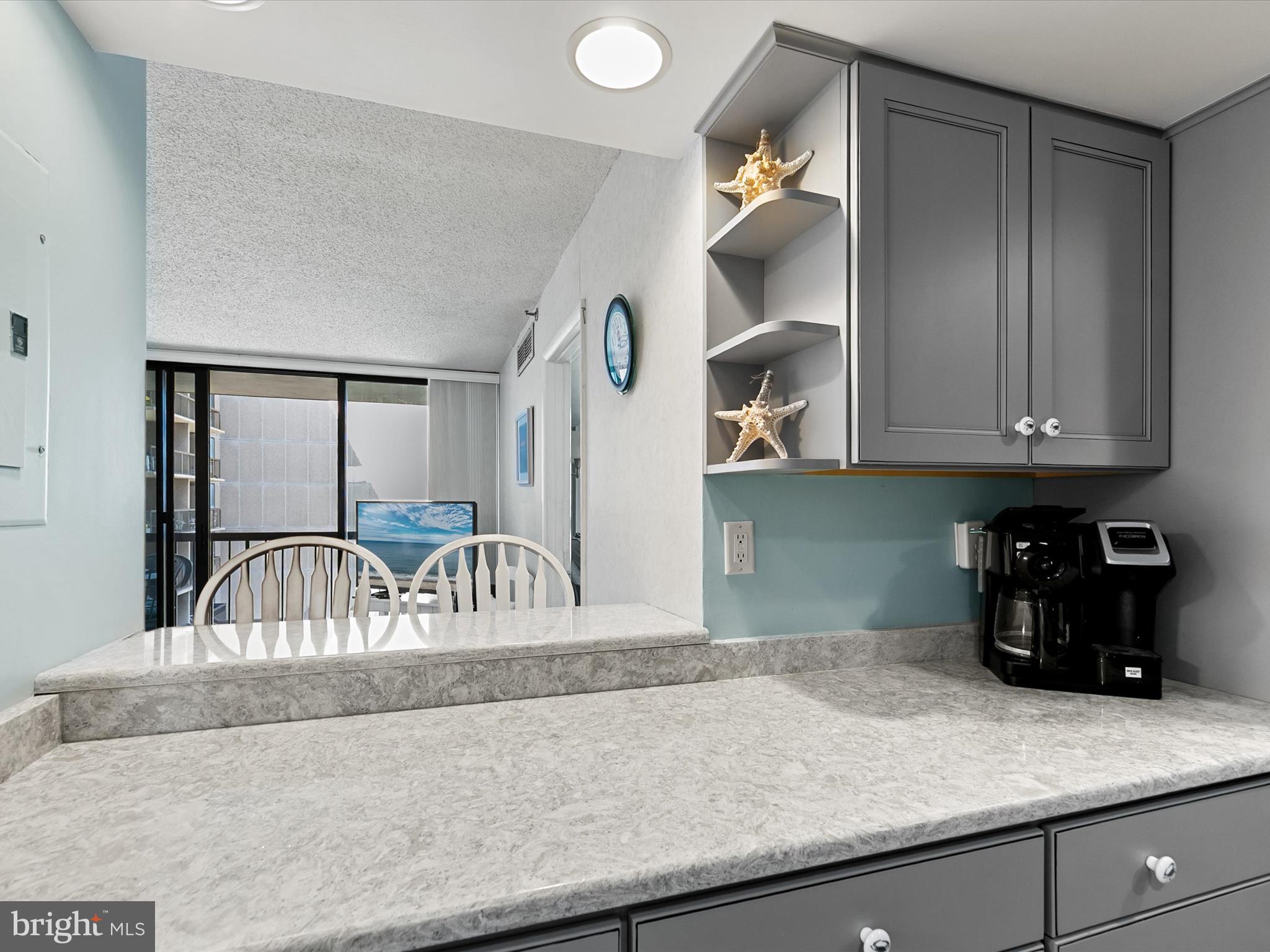 311 Georgetown House Bethany Beach, DE 19930 - Photo 4 of 48 a kitchen with a refrigerator and cabinets