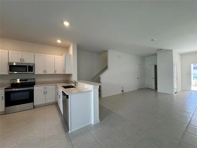 a kitchen with a stove top oven and cabinets