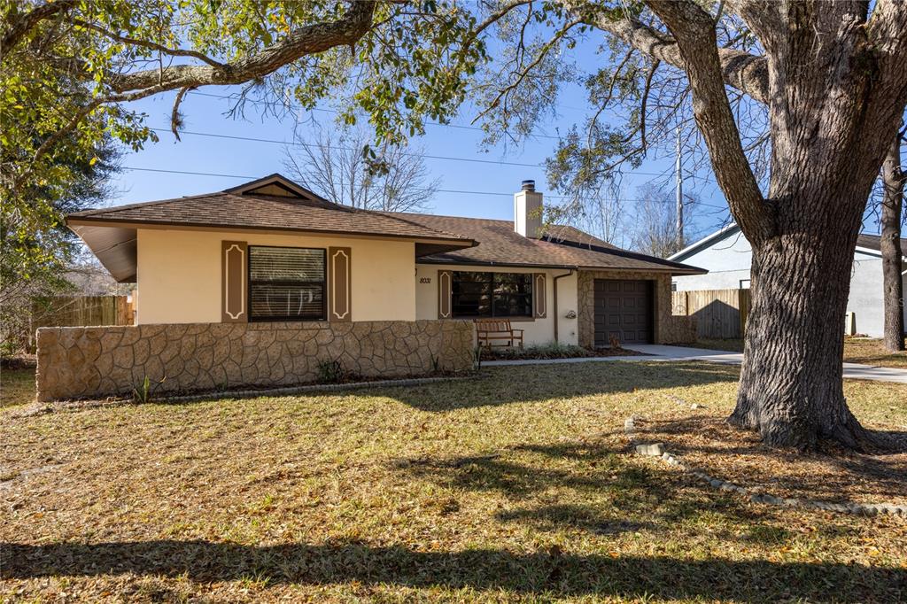 8031 Southwest 13th Road Gainesville, FL 32607 - Photo 1 of 40 a front view of a house with a yard