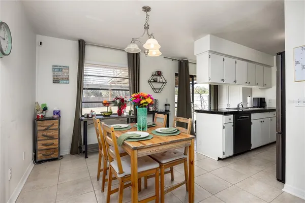 a view of a dining room with furniture and a chandelier